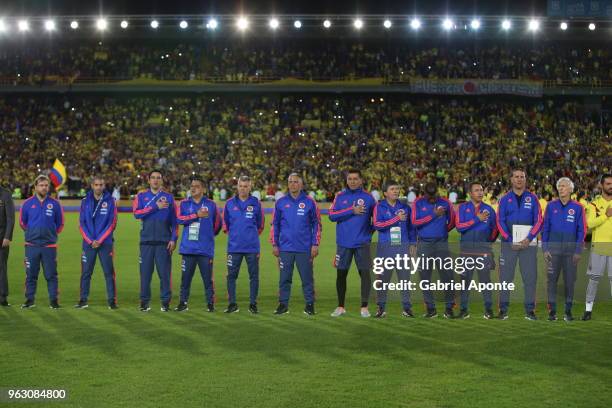 Technical staff of Colombia team sign their National Anthem during a training session open to the public as part of the preparation for FIFA World...