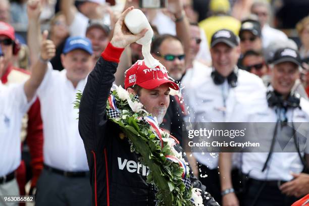 Will Power of Australia, driver of the Verizon Team Penske Chevrolet celebrates by drinking milk after winning the 102nd Running of the Indianapolis...