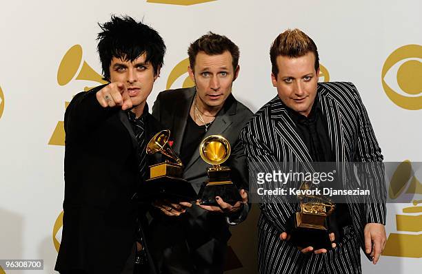 Musicians Billie Joe Armstrong, Mike Dirnt and Tre Cool of Green Day pose with Best Rock Album for '21st Century Breakdown' in the press room during...