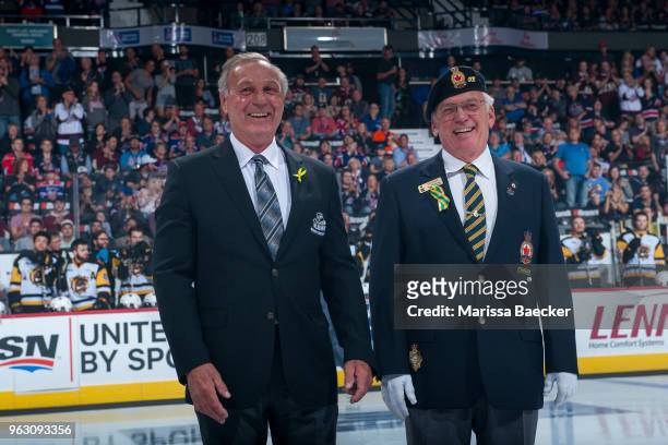 Guy Lafleur, honorary captain of 2018 MasterCard Memorial Cup stands on the ice next to Ron Hitchcock of the Royal Canadian Legion for the puck drop...