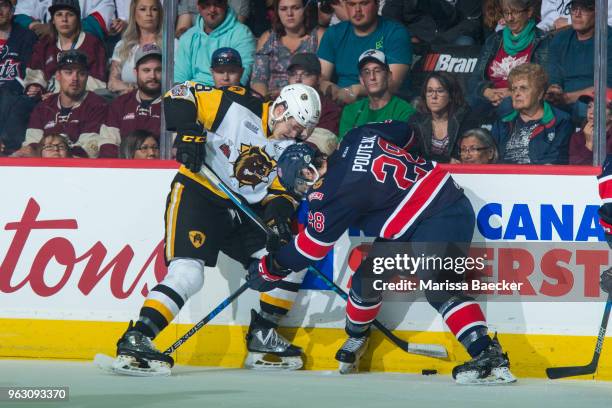 Matthew Strome of Hamilton Bulldogs is checked by Brady Pouteau of Regina Pats during first period at Brandt Centre - Evraz Place on May 25, 2018 in...