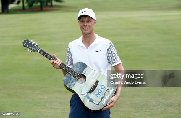 Cameron Davis of Australia holds the winner's trophy after the final round of the Nashville Golf Open at the Nashville Golf and Athletic Club on May...