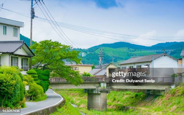 view of canal in yufu city in yufuin, oita, japan - oita japan stockfoto's en -beelden