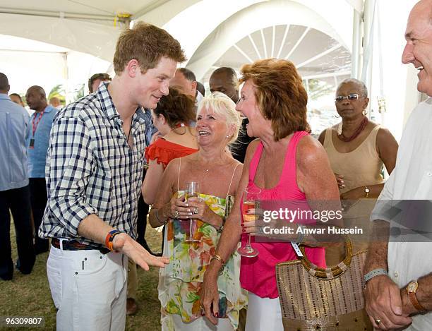 Prince Harry chats to Cilla Black at a reception before the inaugural Sentebale Polo Cup on January 31, 2010 in Apes Hill, Barbados. The Sentebale...