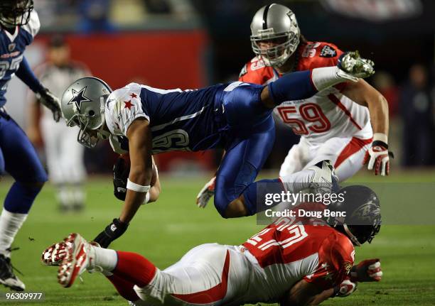 Miles Austin of the Dallas Cowboys gets tackled by Ray Rice of the Baltimore Ravens during the 2010 AFC-NFC Pro Bowl at Sun Life Stadium on January...