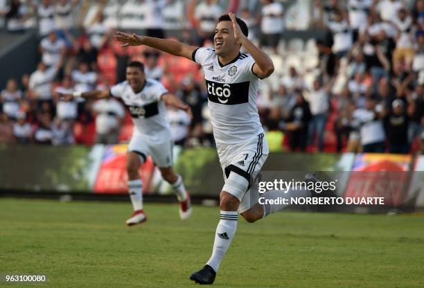 Olimpia's footballer Nestor Camacho celebrates after scoring against of Sol de America, during their Apertura tournament football match at the...