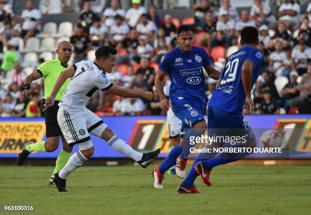 Olimpia's footballer Nestor Camacho , shots to score a goal against of Sol de America, during their Apertura tournament football match at the...