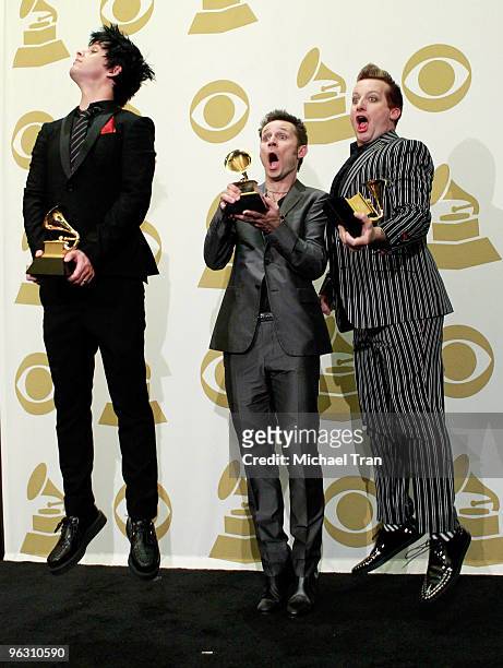 Musicians Billie Joe Armstrong, Mike Dirnt and Tre Cool of Green Day pose in the press room at the 52nd Annual GRAMMY Awards held at Staples Center...