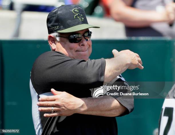 Manager Rick Renteria of the Chicago White Sox signals to second baseman Yoan Moncada of the Chicago White Sox after Moncada caught a fly ball hit by...