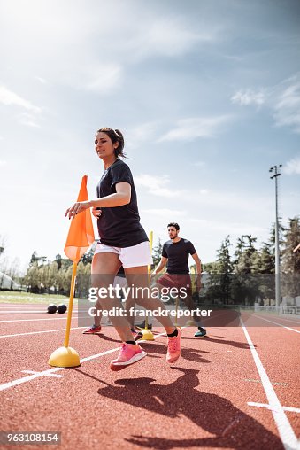 Friends running on the track field Friends running on the track field