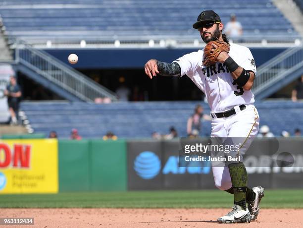 Sean Rodriguez of the Pittsburgh Pirates throws to first base for a force out of Marcell Ozuna of the St. Louis Cardinals in the ninth inning during...