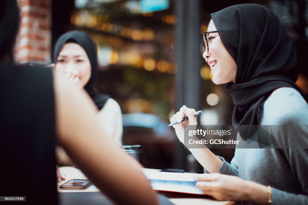 Malaysian students having banter at a cafe