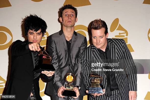 Musicians Billie Joe Armstrong, Mike Dirnt and Tre Cool of Green Day pose in the press room at the 52nd Annual GRAMMY Awards held at Staples Center...