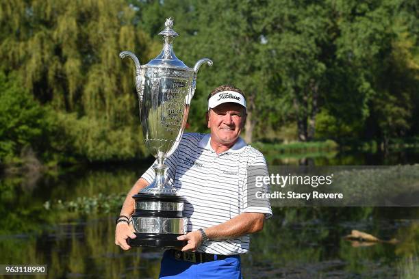 Paul Broadhurst of England poses with the Alfred S. Bourne Trophy after winning the Senior PGA Championship presented by KitchenAid at the Golf Club...