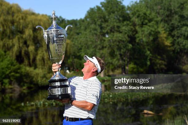 Paul Broadhurst of England poses with the Alfred S. Bourne Trophy after winning the Senior PGA Championship presented by KitchenAid at the Golf Club...