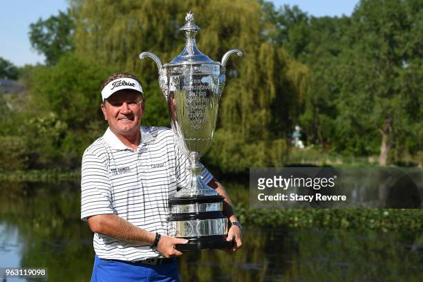 Paul Broadhurst of England poses with the Alfred S. Bourne Trophy after winning the Senior PGA Championship presented by KitchenAid at the Golf Club...