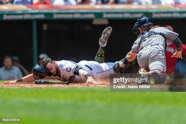 Jason Kipnis of the Cleveland Indians scores on a hit by Jose Ramirez during the second inning as catcher Max Stassi of the Houston Astros tries to...