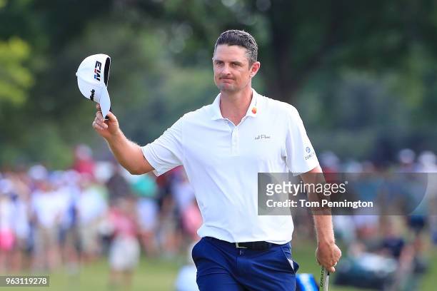 Justin Rose of England acknowledges the crowd as he walks up to the 18th green during the final round of the Fort Worth Invitational at Colonial...
