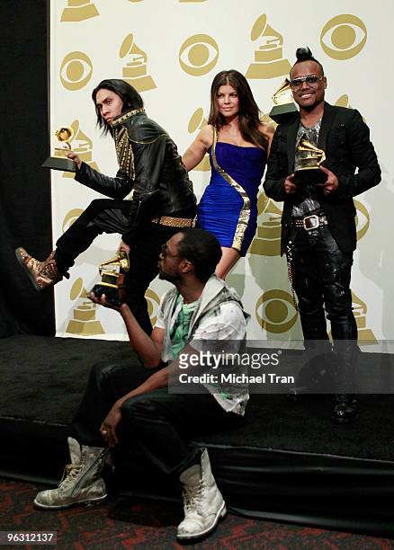 Musicians Taboo, Fergie, apl.de.ap, and will.i.am of the music group the Black Eyed Peas pose in the press room at the 52nd Annual GRAMMY Awards held...