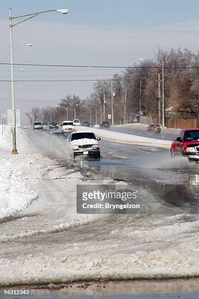 traffic in the melting snow - snow melting on car stock pictures, royalty-free photos & images