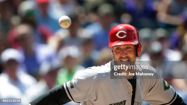 Matt Harvey of the Cincinnati Reds dodges the ball as he runs to first base on his ground out in the in the fourth inning against the Colorado...