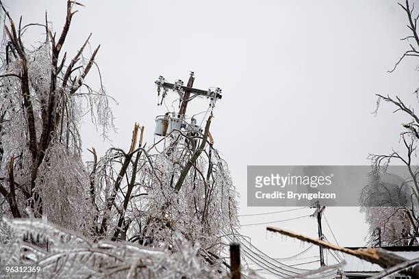 icy power pole falling - winter_storm stock pictures, royalty-free photos & images