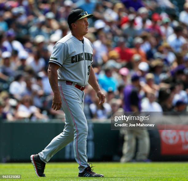 Jim Riggleman of the Cincinnati Reds walks to the mound to changes pitchers against Colorado Rockies at Coors Field on May 27, 2018 in Denver,...