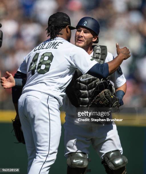 Catcher Chris Herrmann of the Seattle Mariners and relief pitcher Alex Colome of the Seattle Mariners celebrate after a game against the Minnesota...