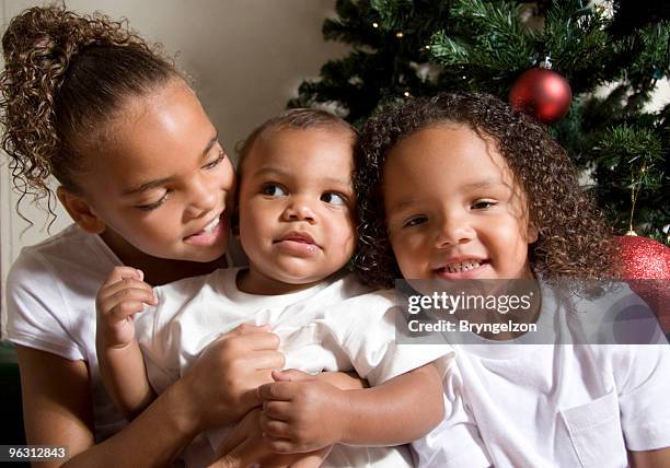 happy children at christmas - sibling christmas stock pictures, royalty-free photos & images