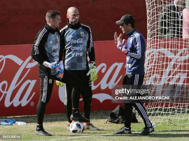Argentina's national football team goalies Franco Armani and Wilfredo Caballero receive instructions from the goalkeepers' coach Martin Tocalli,...