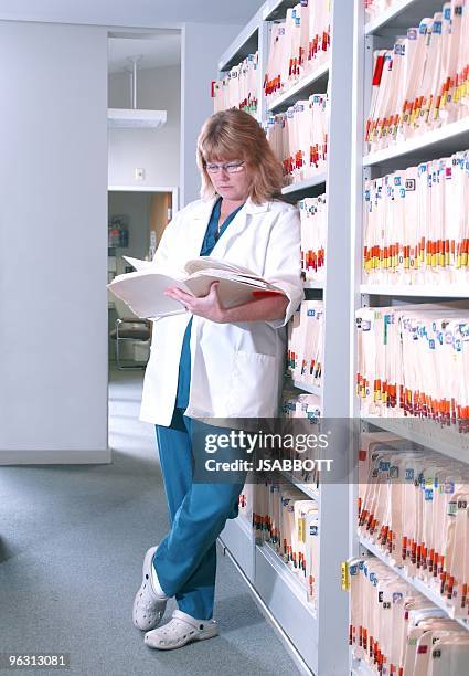 Patient Reading Reference Reading A Patients Chart High-Res Stock Photo - Getty Images