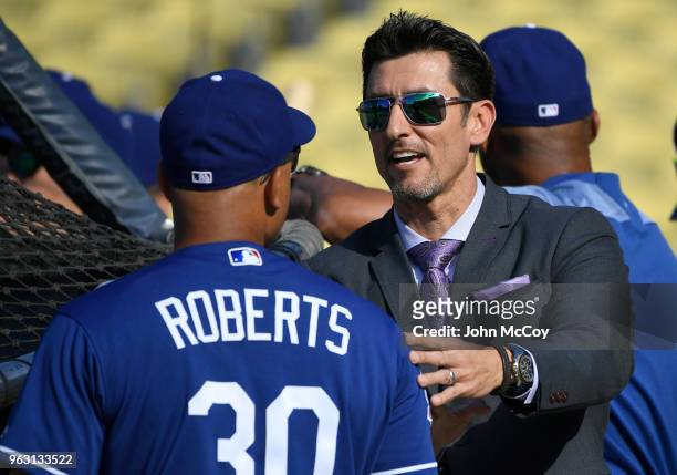 Former Dodger Nomar Garciaparra talks with Dave Roberts of the Los Angeles Dodgers before the Los Angeles Dodgers played the San Diego Padres at...