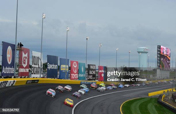 Kyle Busch, driver of the M&M's Red White & Blue Toyota, and Joey Logano, driver of the Shell Pennzoil Ford, lead the field during the Monster Energy...