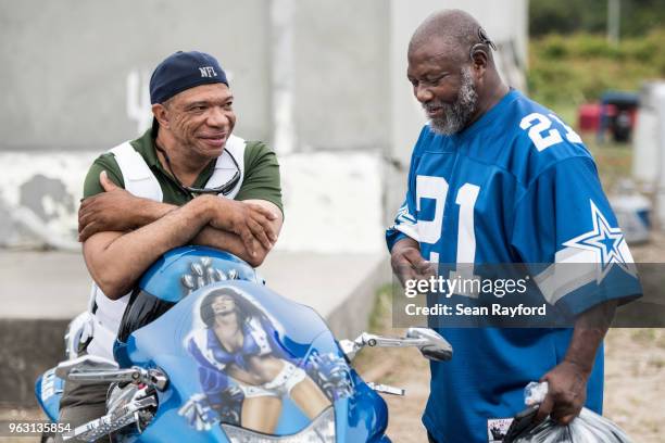 Douglas Rowell, right, talks with a man about his Dallas Cowboys themed motorcycle during Black Bike Week on May 27, 2018 in Atlantic Beach, South...