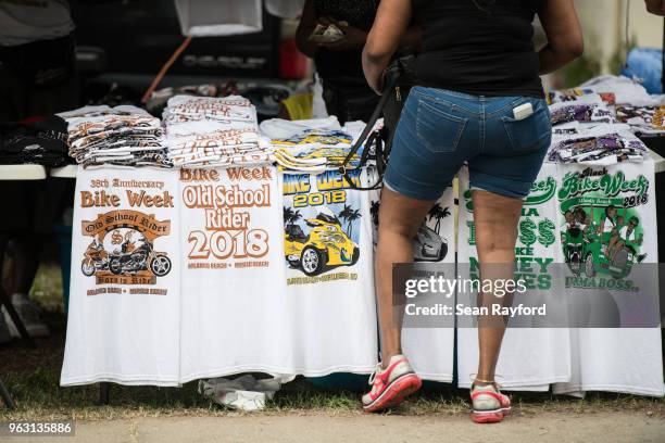 Woman purchases merchandise during Black Bike Week on May 27, 2018 in Atlantic Beach, South Carolina. Also known as Atlantic Beach Bikefest and Black...