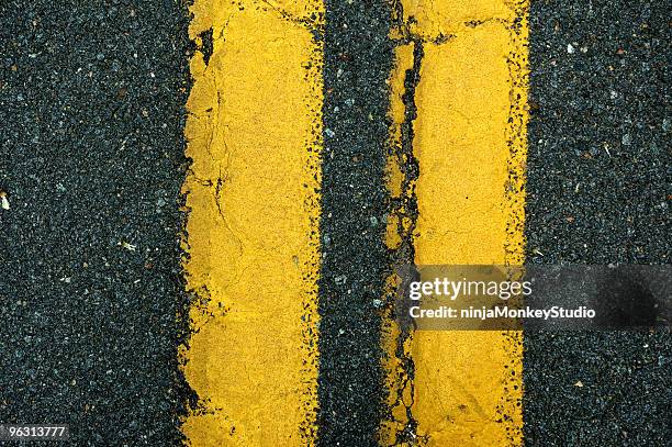 yellow lane divider - symmetry stock pictures, royalty-free photos & images