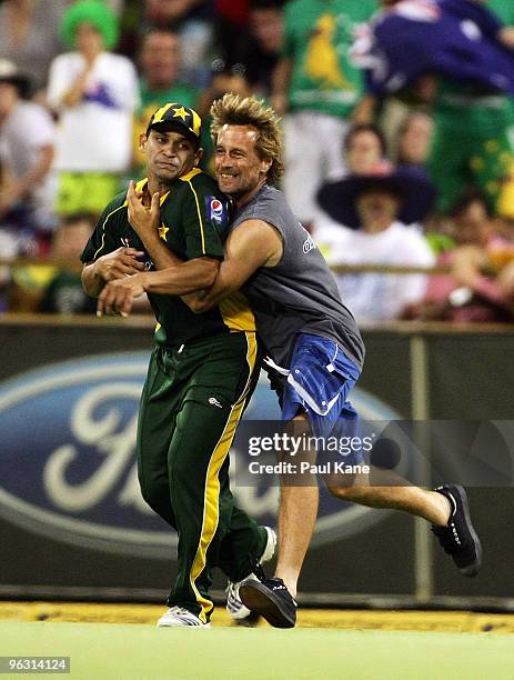 Pitch invader tackles Khalid Latif of Pakistan during the fifth One Day International match between Australia and Pakistan at WACA on January 31,...