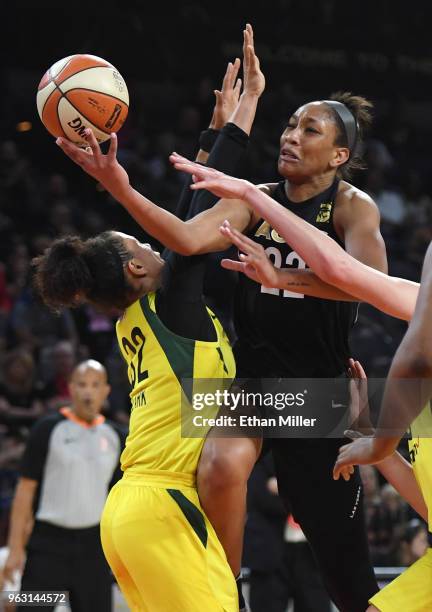 Ja Wilson of the Las Vegas Aces drives to the basket against Alysha Clark of the Seattle Storm during the Aces' inaugural regular-season home opener...