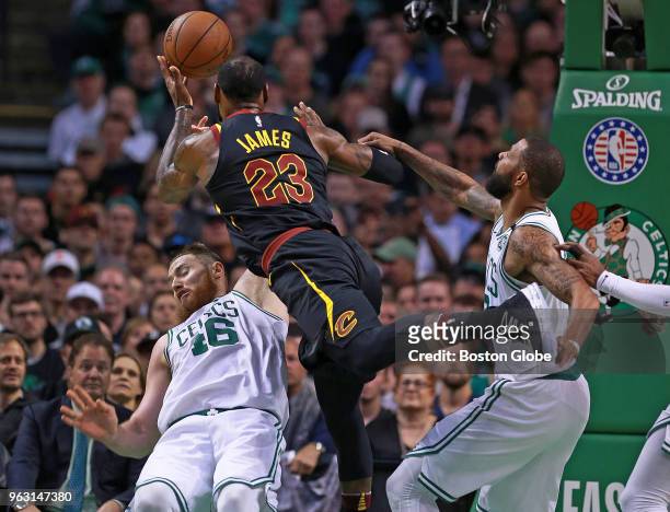 Cleveland Cavaliers' LeBron James drives to the hoop as Boston Celtics Aron Baynes and Marcus Morris defend in the first house. The Boston Celtics...