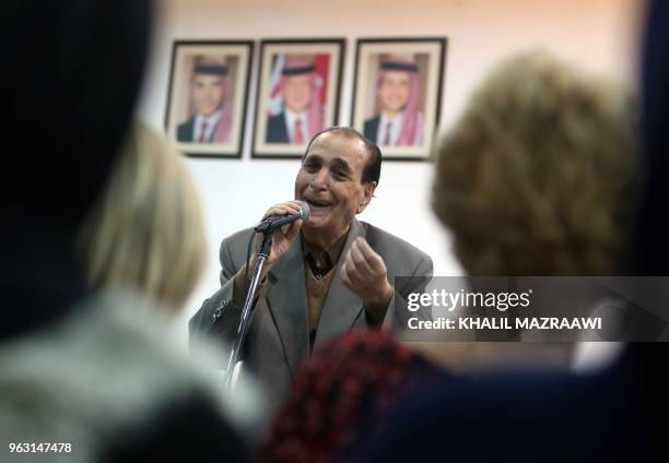 Jordanian singer Mohamed Wahib sings with the Beit al-Rowwad ensemble during a concert at Hussein Cultural Center in Amman on March 13, 2018. - Beit...