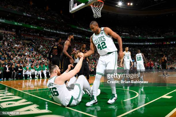 Al Horford helps Aron Baynes of the Boston Celtics from the floor during Game Seven of the Eastern Conference Finals of the 2018 NBA Playoffs between...
