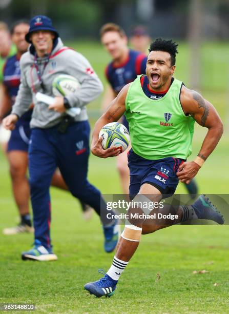 Will Genia of the Rebels reacts while as he runs with the ball away to the line from teammates during a Melbourne Rebels Super Rugby training session...