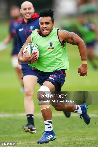 Will Genia of the Rebels reacts while as he runs with the ball away to the line from teammates during a Melbourne Rebels Super Rugby training session...