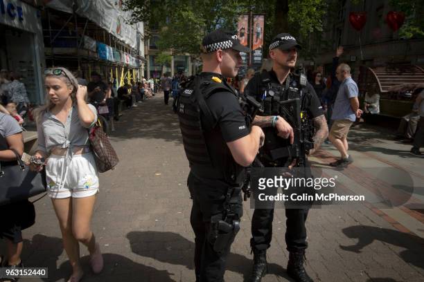 Armed police on patrol in St. Ann's Square, Manchester after the holding of a minute's silence in memory of the bomb attack the previous Monday at...