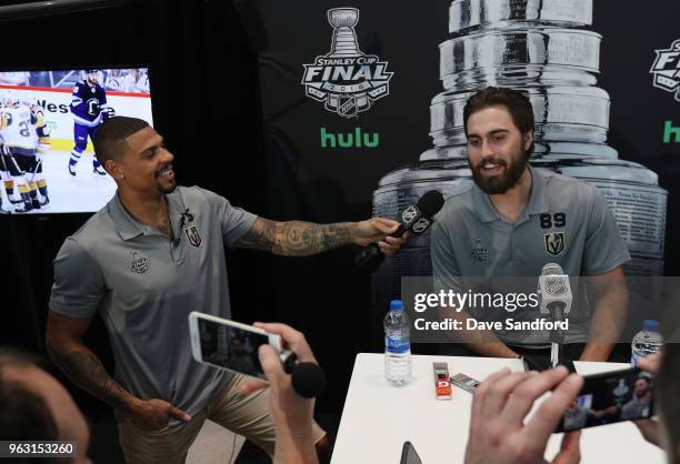 Ryan Reaves of the Vegas Golden Knights asks questions to teammate Alex Tuch of the Vegas Golden Knights during Media Day for the 2018 NHL Stanley...