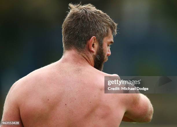 International recruit Geoff Parling of the Rebels looks down on his troublesome shoulder as he waits to have it restrapped during a Melbourne Rebels...