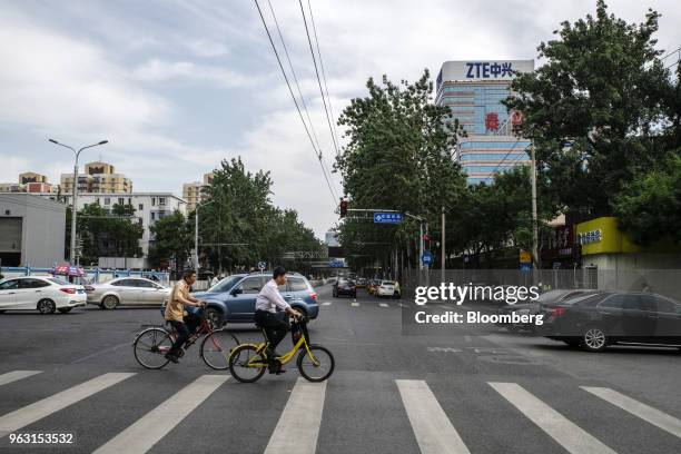 Vehicles travel through an intersection near a ZTE Corp. Building in Beijing, China, on Thursday, May 24, 2018. President Donald Trump said the U.S....