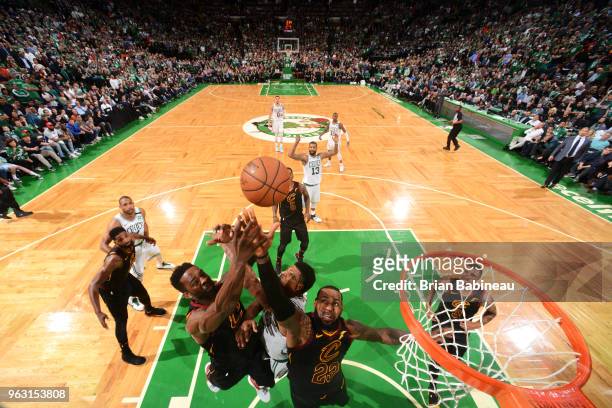 Jeff Green and LeBron James of the Cleveland Cavaliers reach for the ball against Marcus Smart of the Boston Celtics during Game Seven of the Eastern...