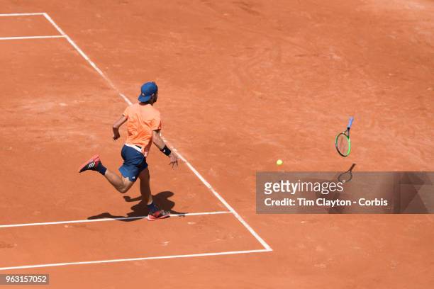 French Open Tennis Tournament - Lucas Pouille of France throws his racquet at the ball after it has passed him much to the delight of the crowd while...