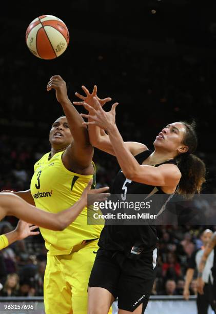 Courtney Paris of the Seattle Storm and Dearica Hamby of the Las Vegas Aces fight for a rebound during the Aces' inaugural regular-season home opener...